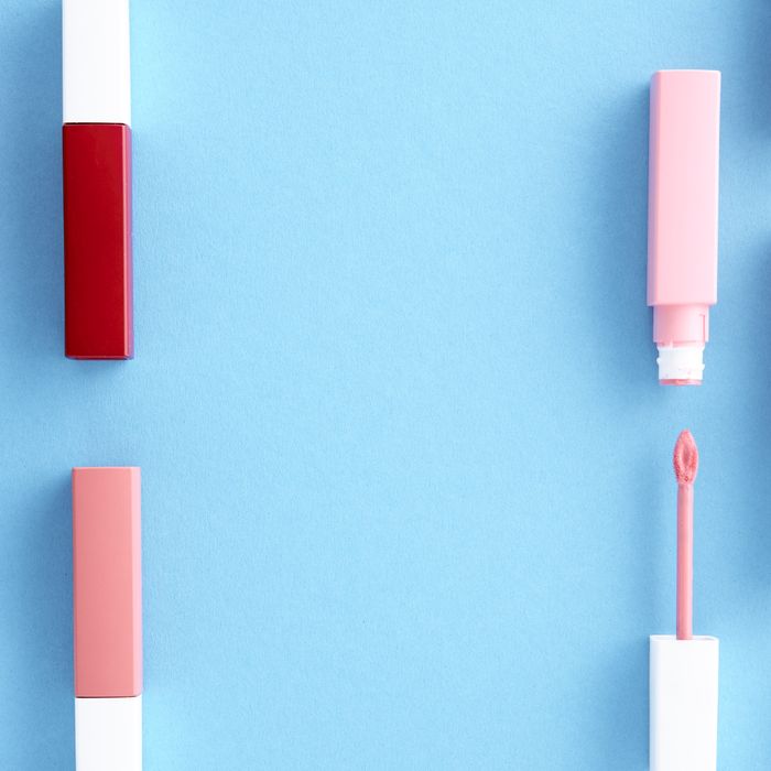 Row of lipsticks on a blue background